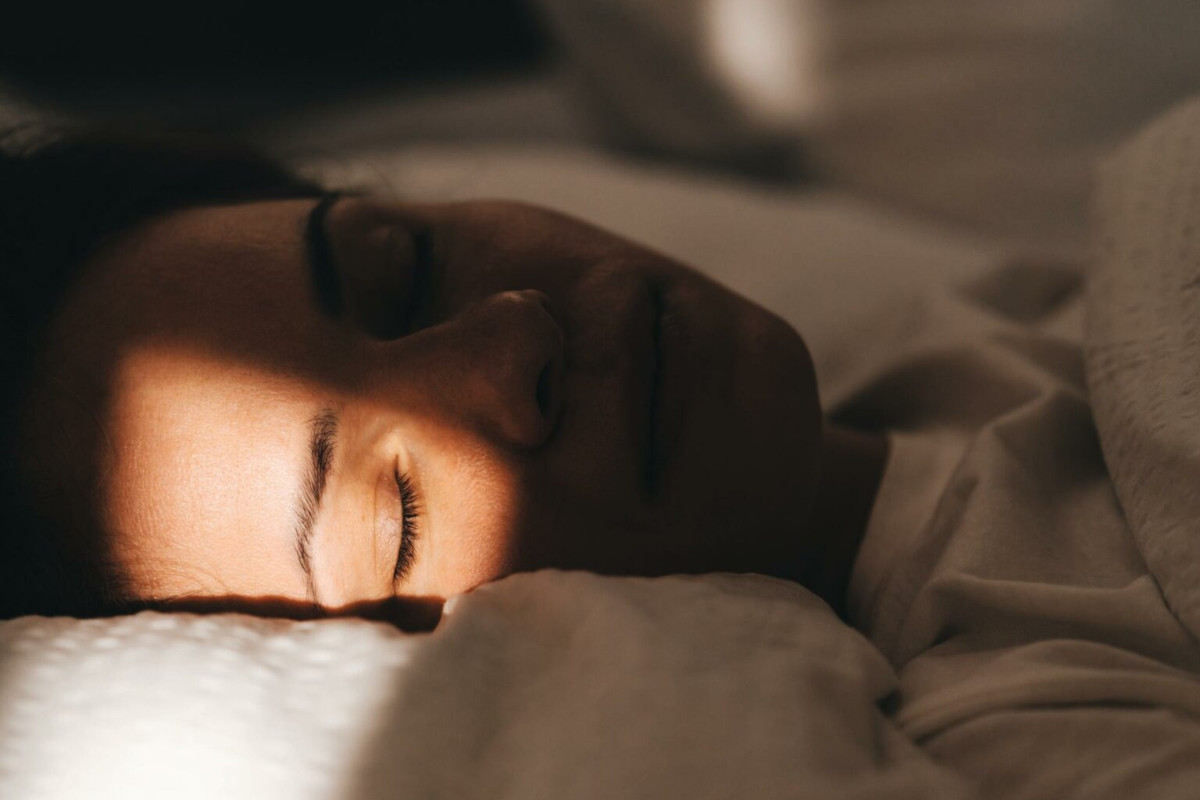 Close up of someone's face asleep in bed