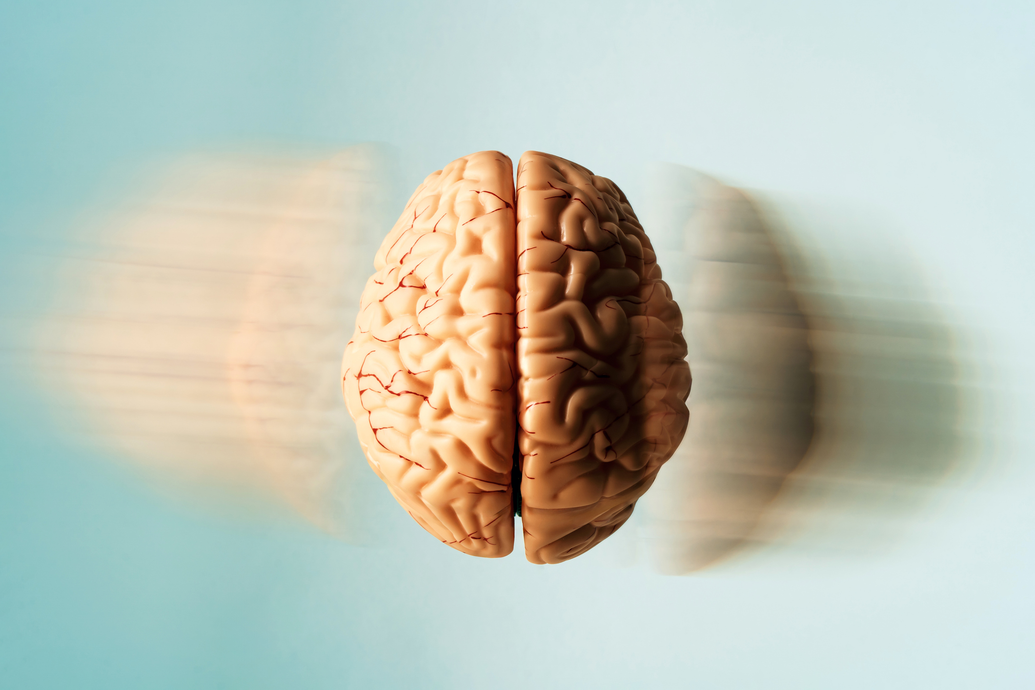 Floating human brain with motion blur to suggest rapid thought