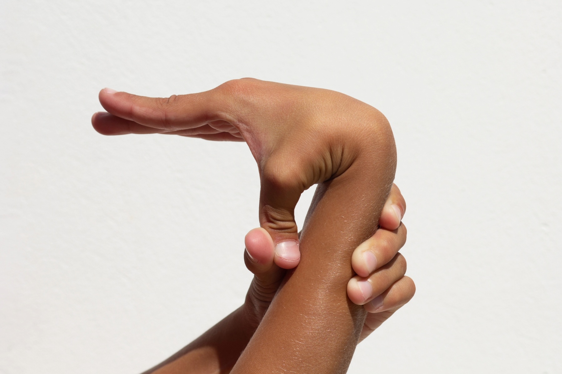 Person holding their thumb against their wrist