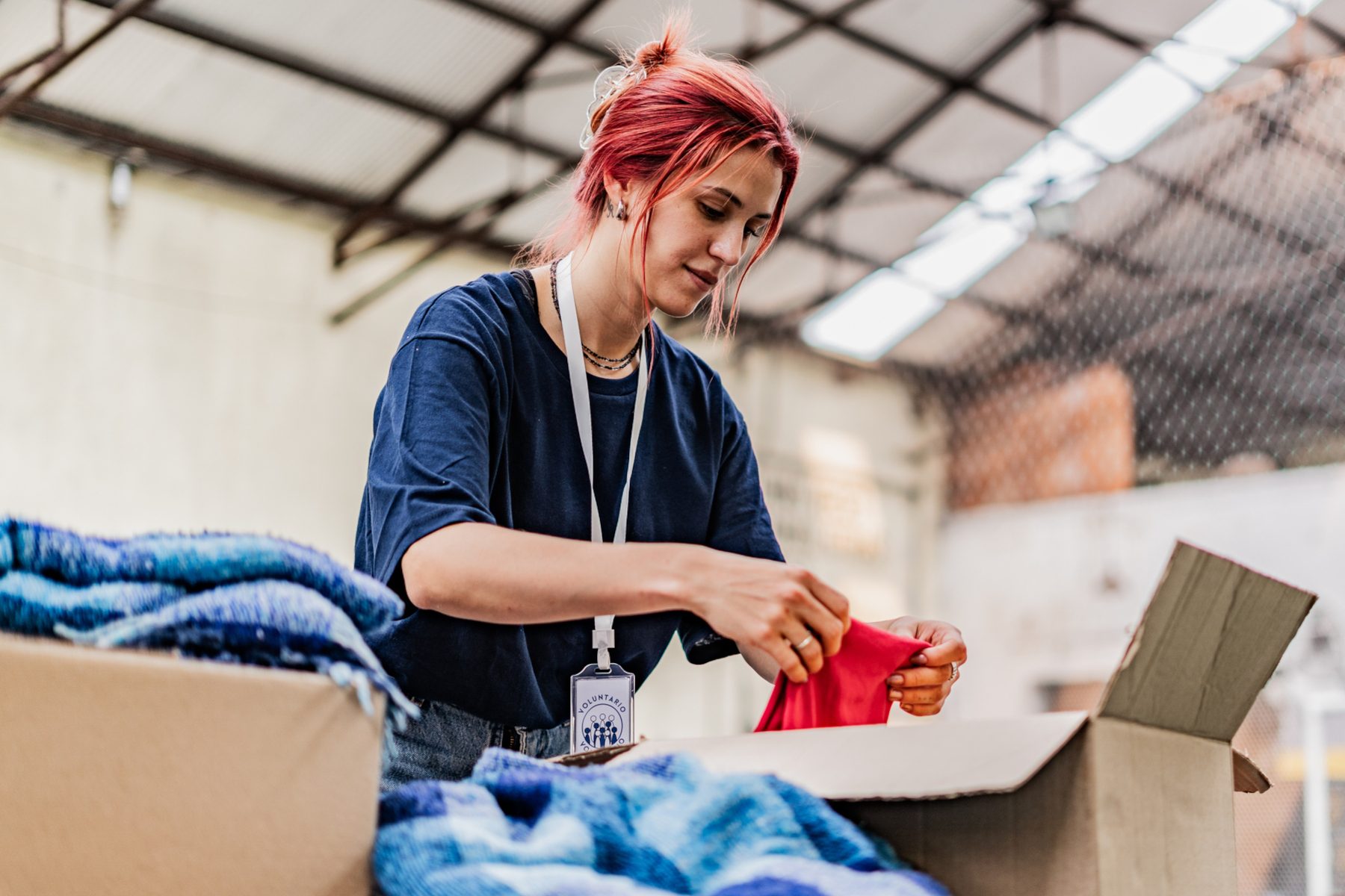 Volunteer arranging donations in a community charity donation center