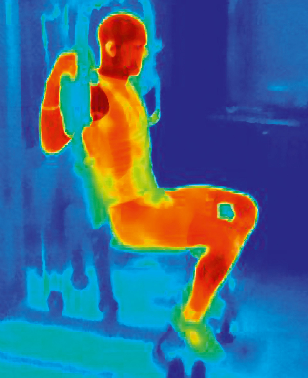 Thermal image of athlete training on exercise machine. Image shows the heat produced by the muscles during training