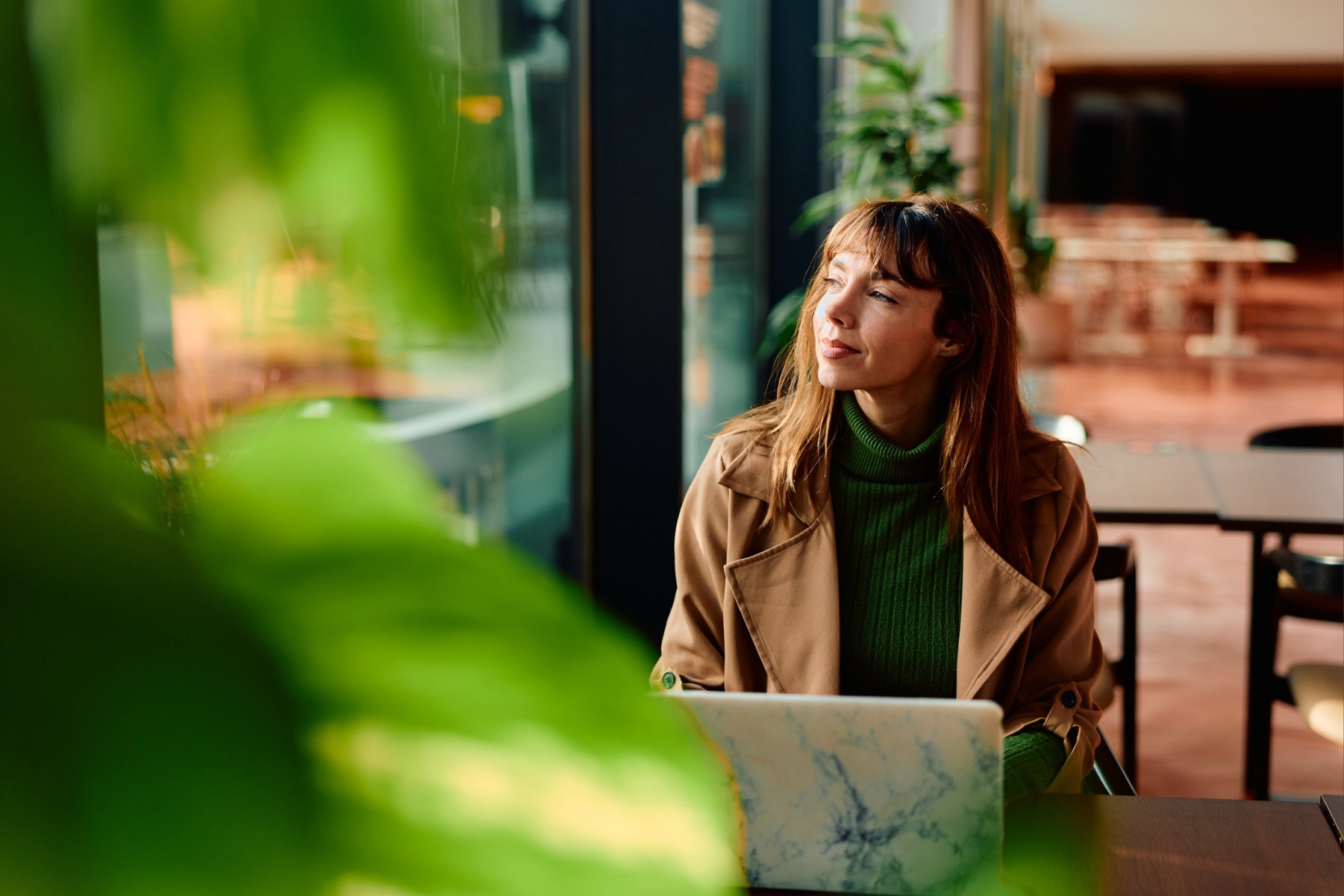 Woman daydreaming in cafe