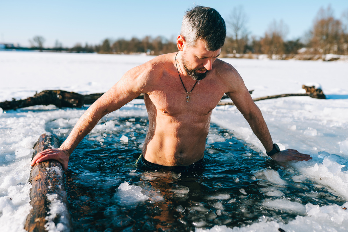 Courageous man immersing himself in icy water for a winter health ritual