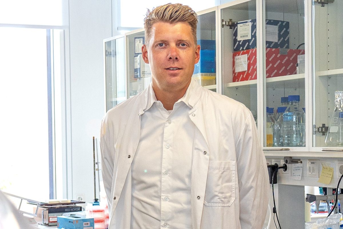 Photo of Prof Morten Scheibye-Knudsen wearing a lab coat and looking down the camera