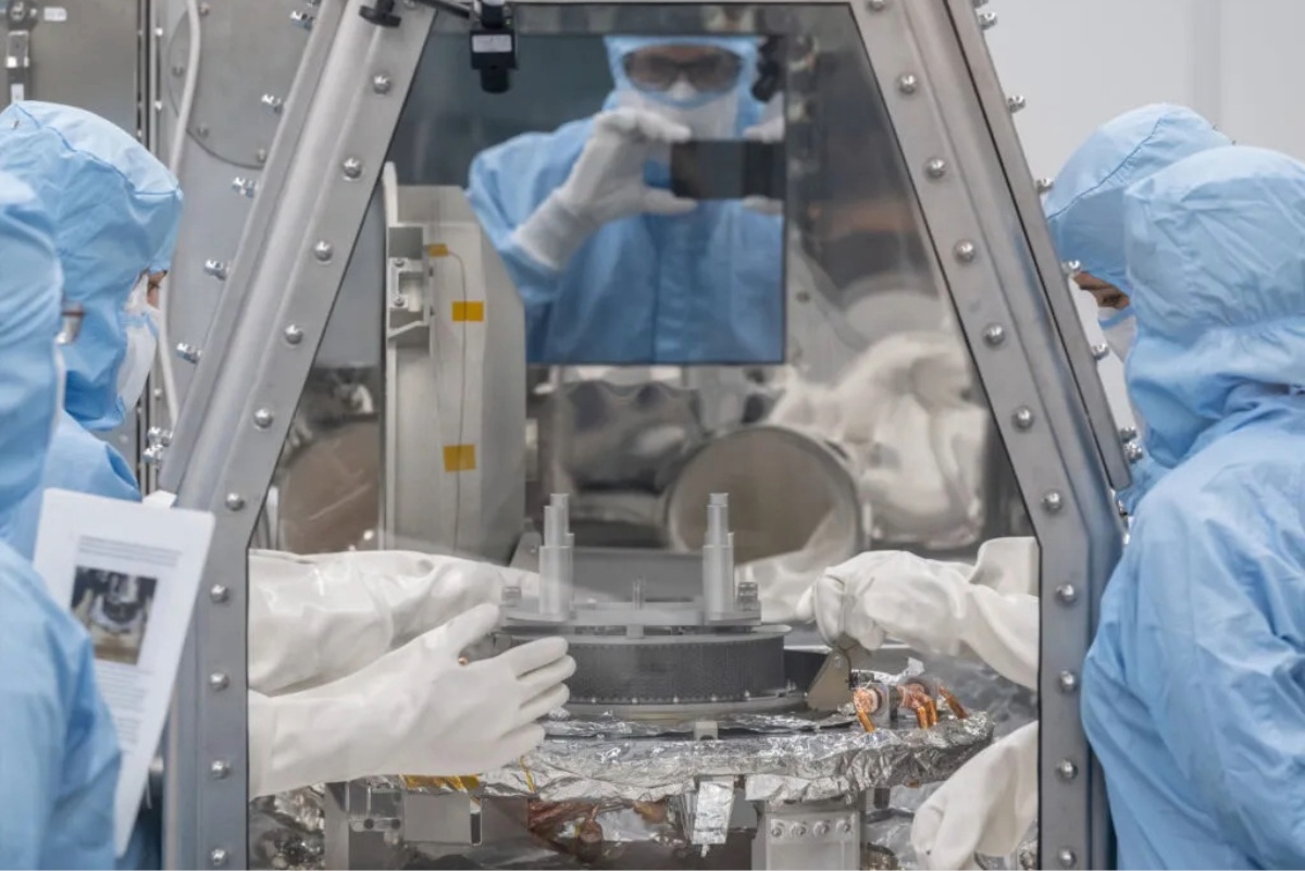 Scientists working in a hood looking at samples