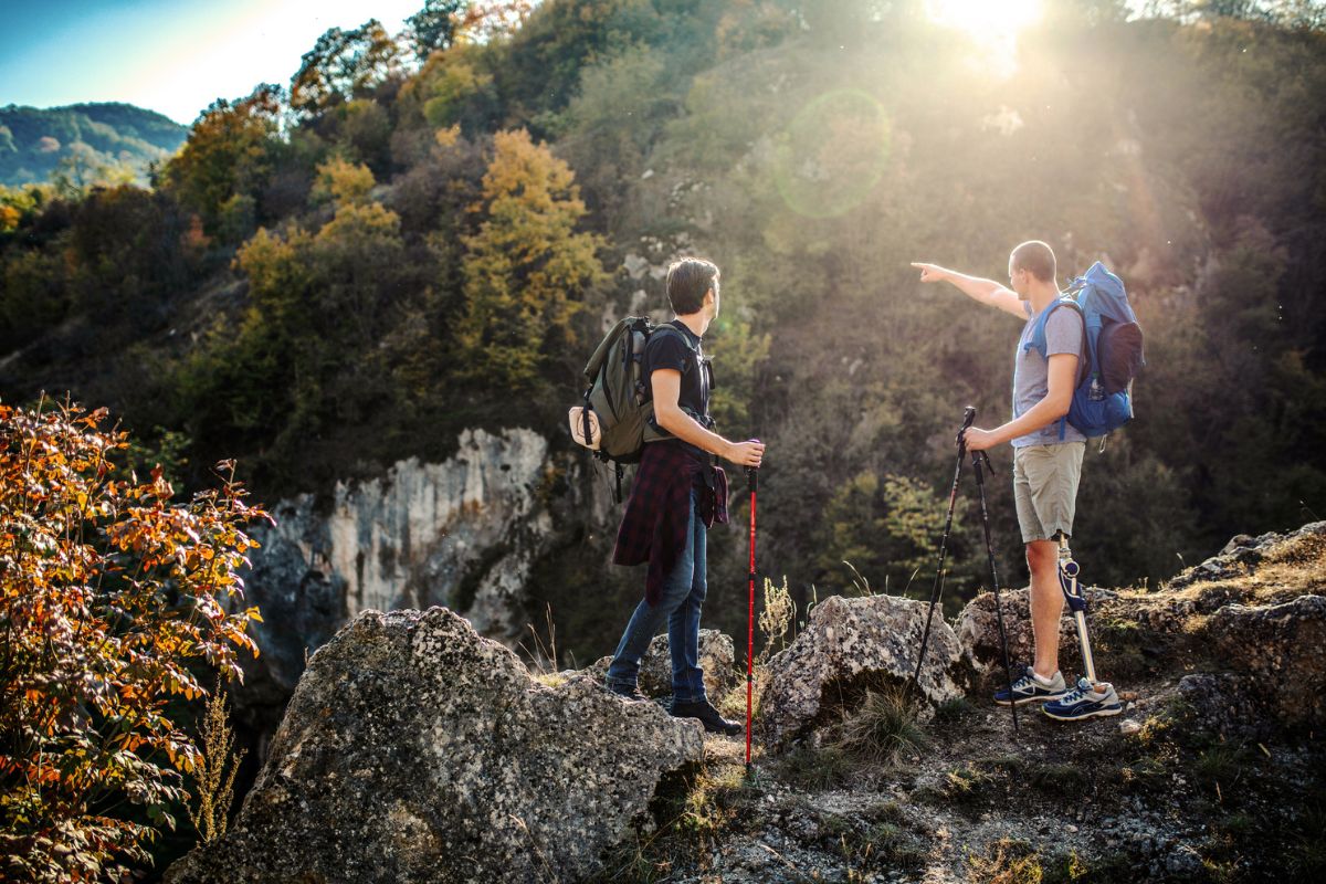 Two men hike through nature together