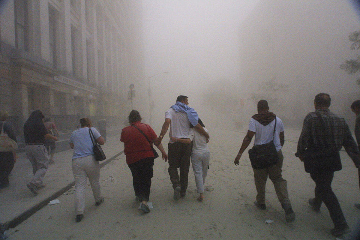 Civilians flee as a tower of the World Trade Center collapses