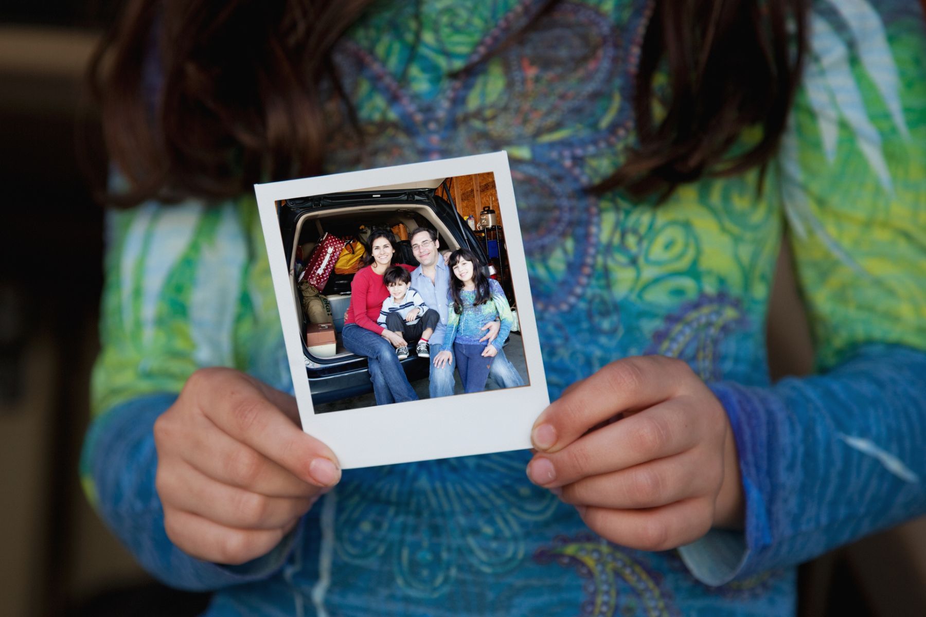 A girl holds a family photo