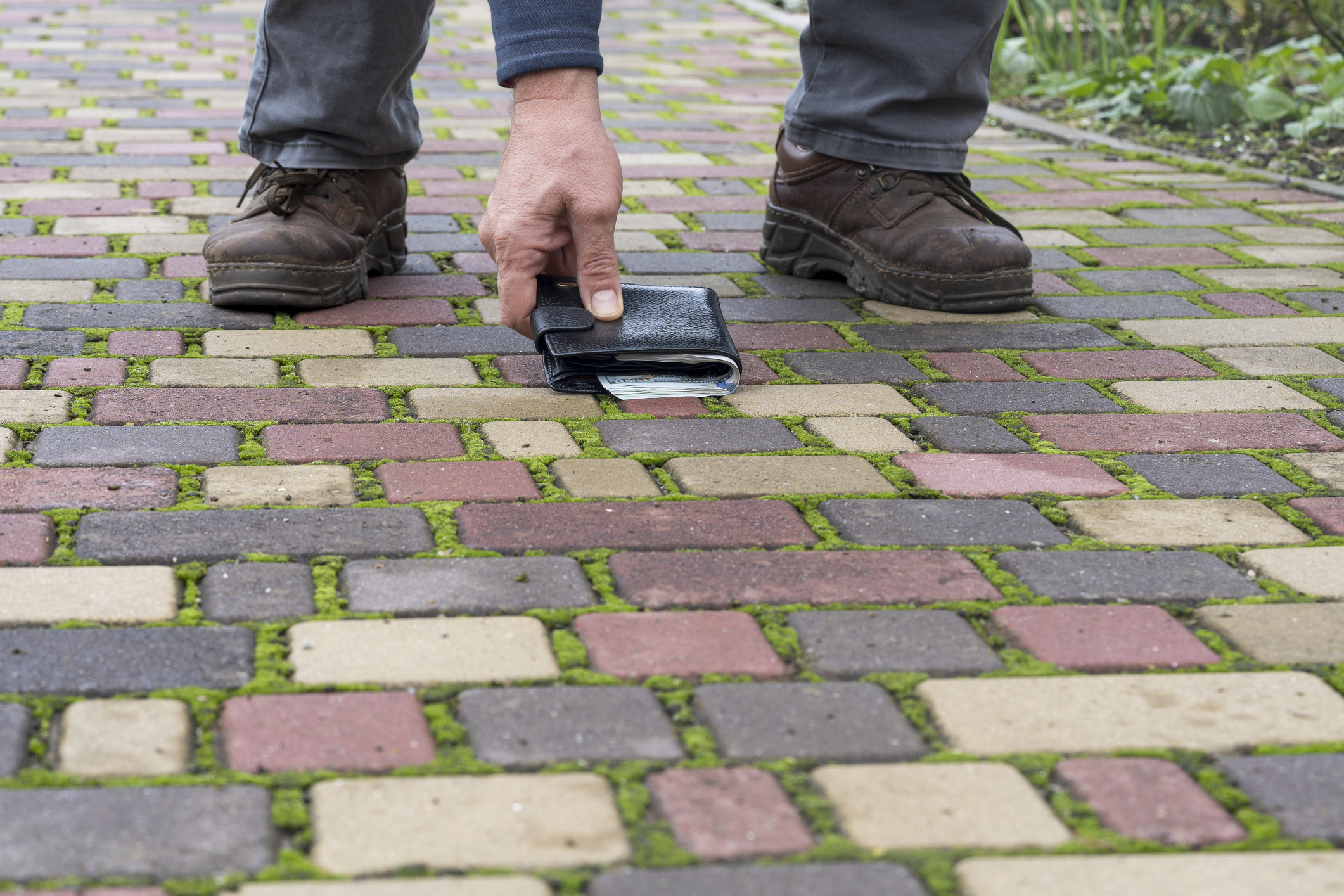Man picks up wallet from ground
