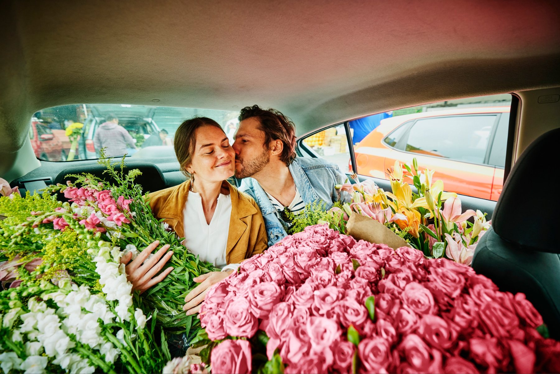 Couple in a taxi surrounded by flowers