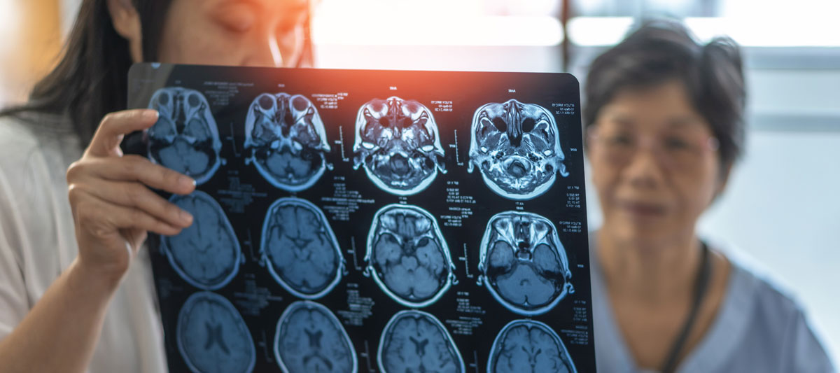 A doctor and patient looking at brain scans.