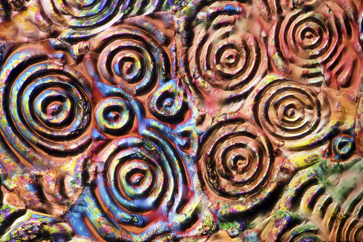 Multicoloured swirls interacting.