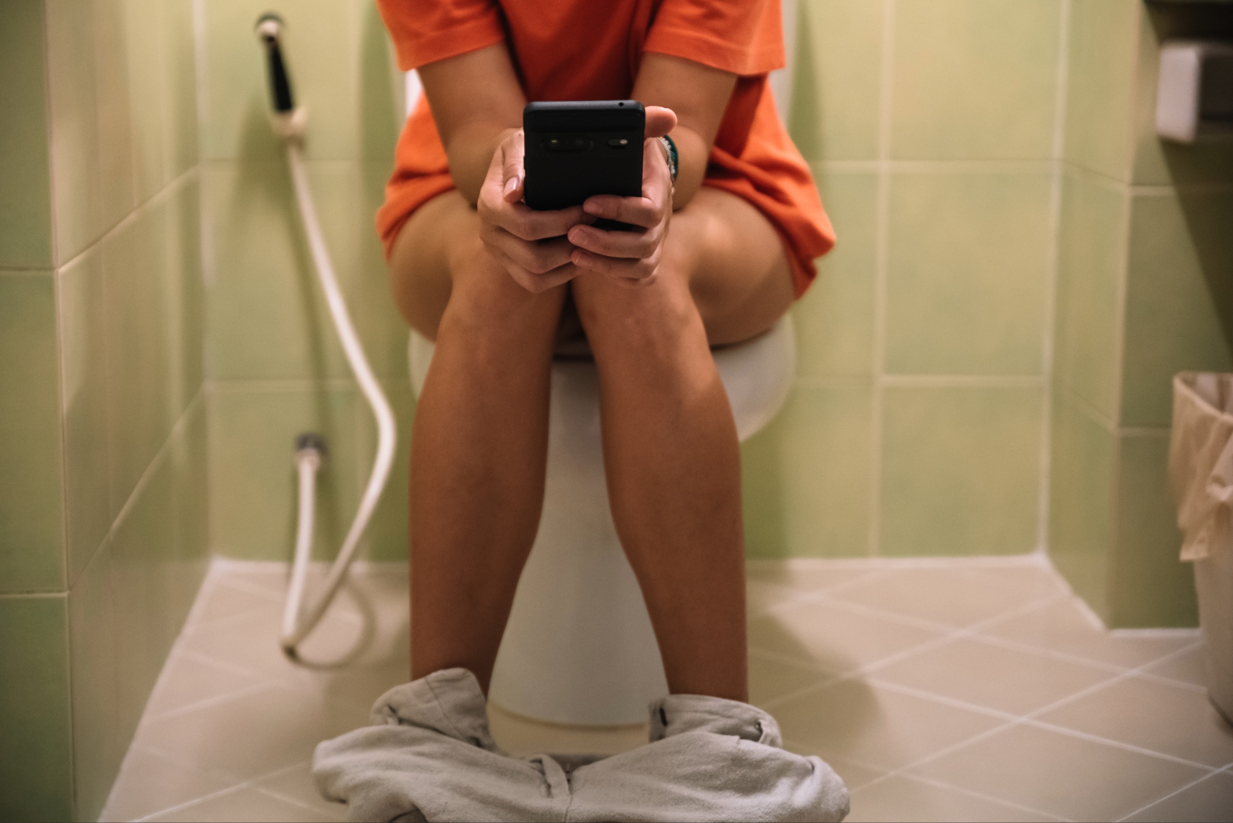 Person sitting on toilet