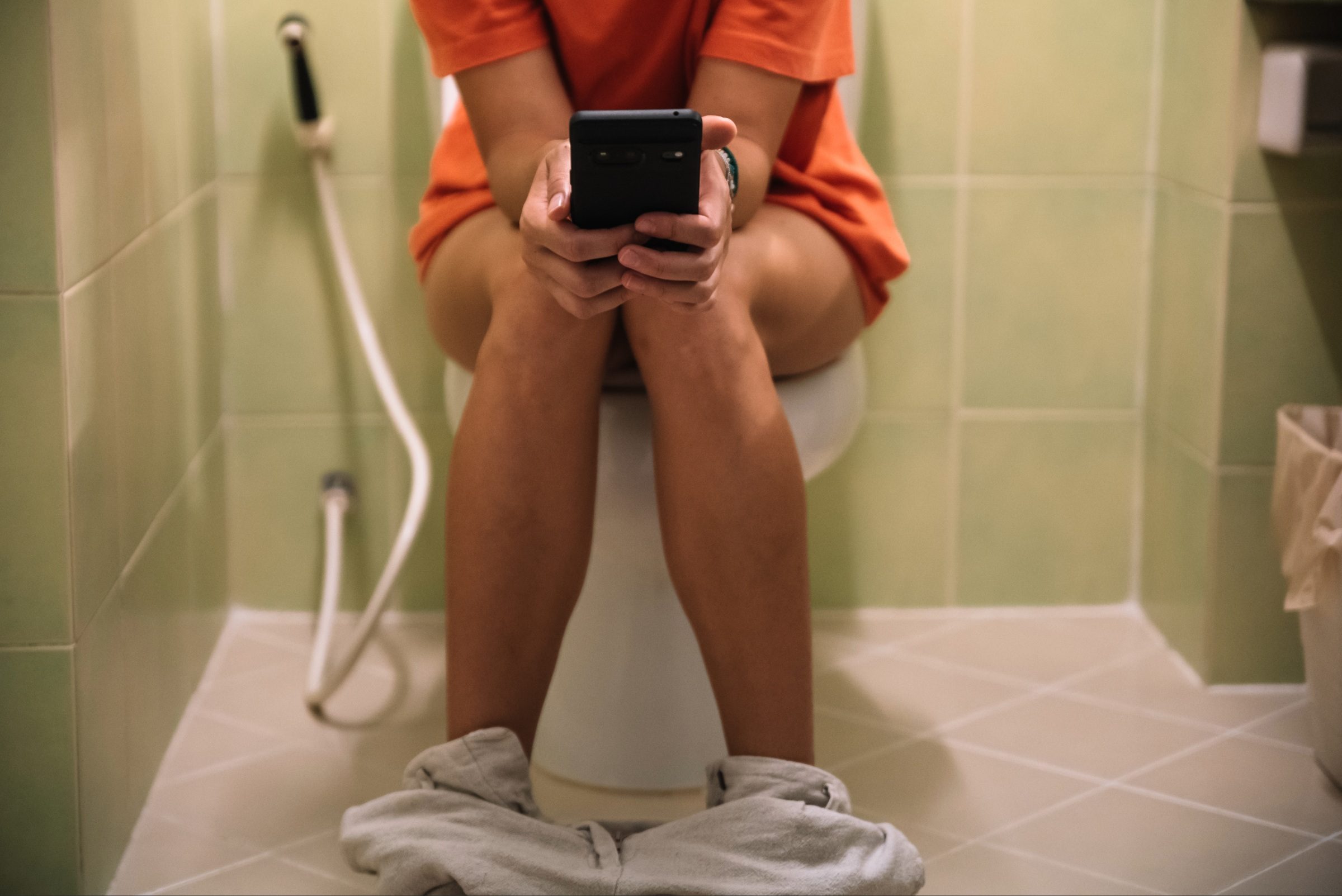 Person sitting on toilet