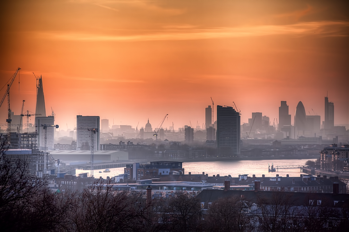 Dusk view of London as sun sets and smog rises.