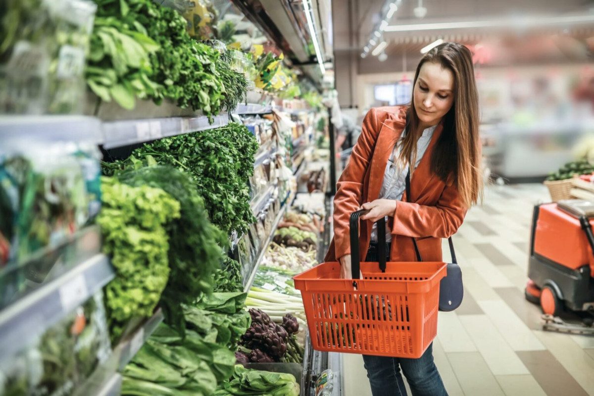 A person shopping for vegetables in a supermarket