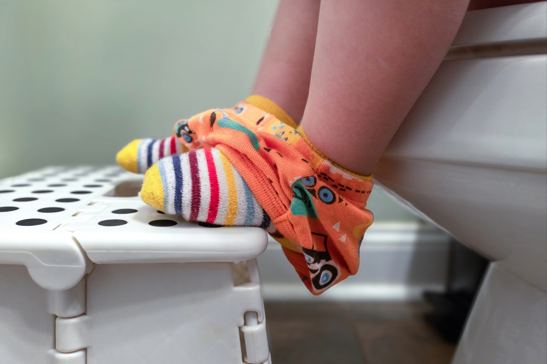 Child with feet on footstool