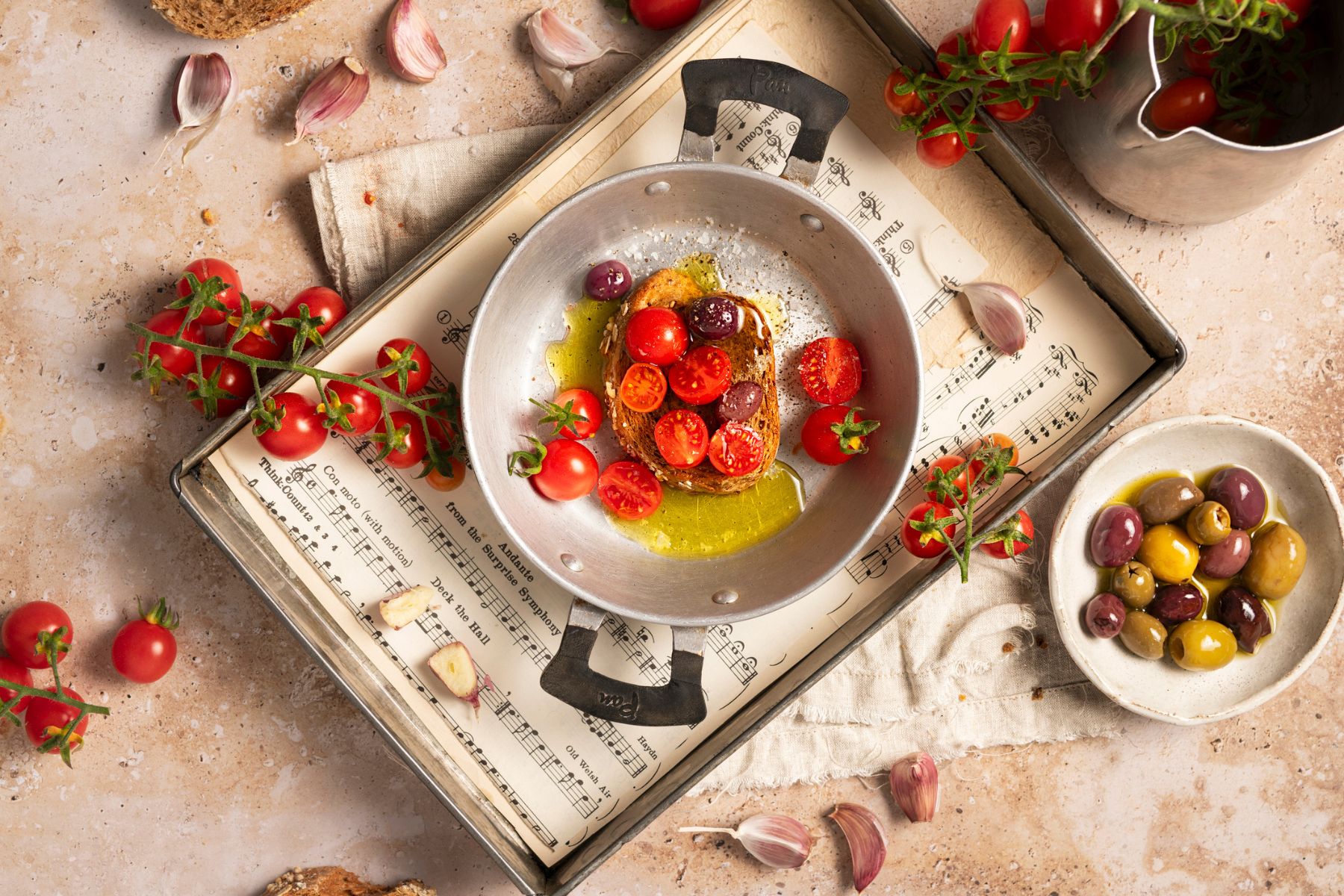 Bruschetta: tomatoes on sourdough bread with olive oil, olives and garlic