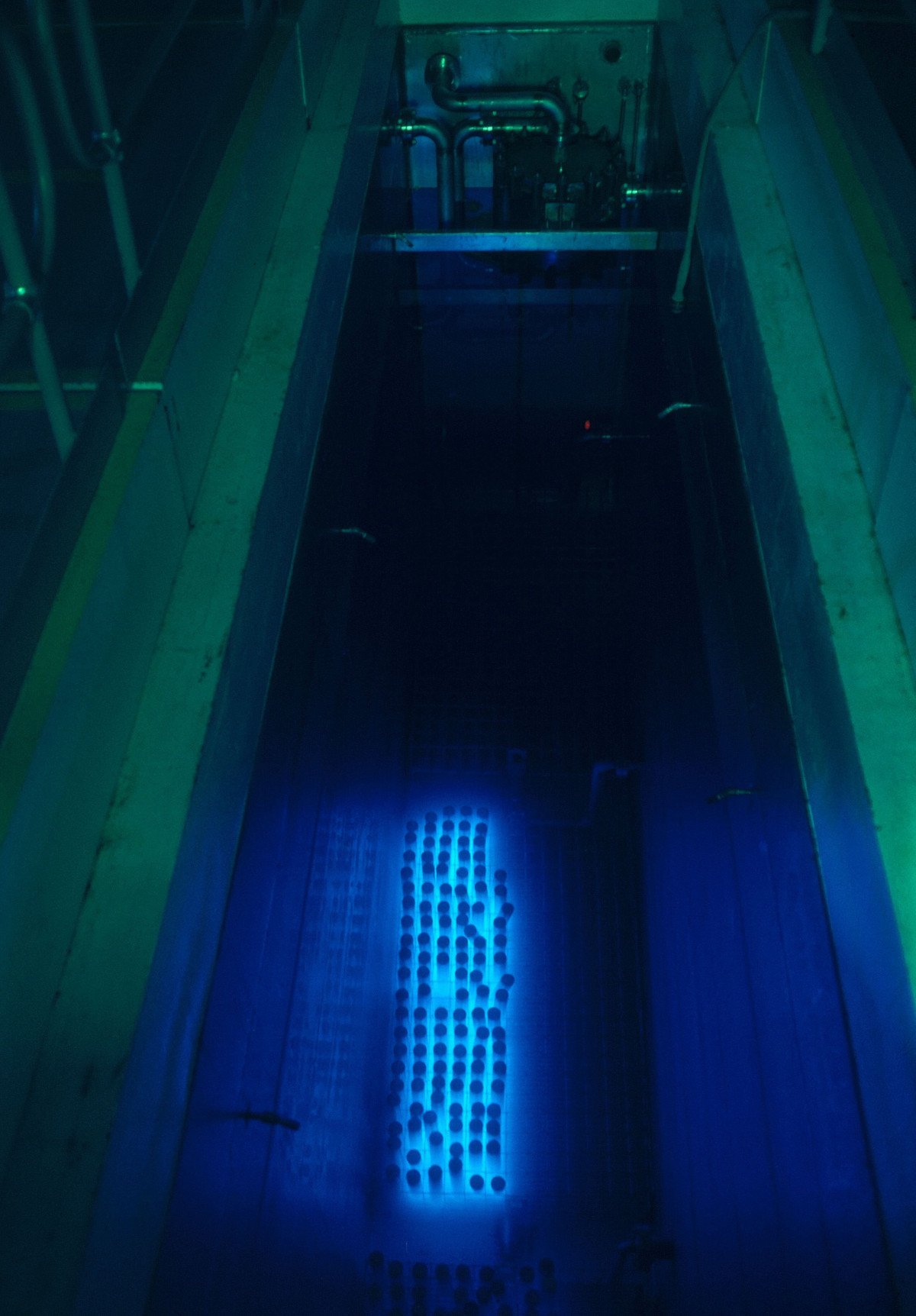 Cesium 135 and strontium 90 in water storage at the Hanford Atomic Reservation in Washington. The radioactive decay gives off high-speed particles that travel faster than light does through the water, giving it an eerie blue glow
