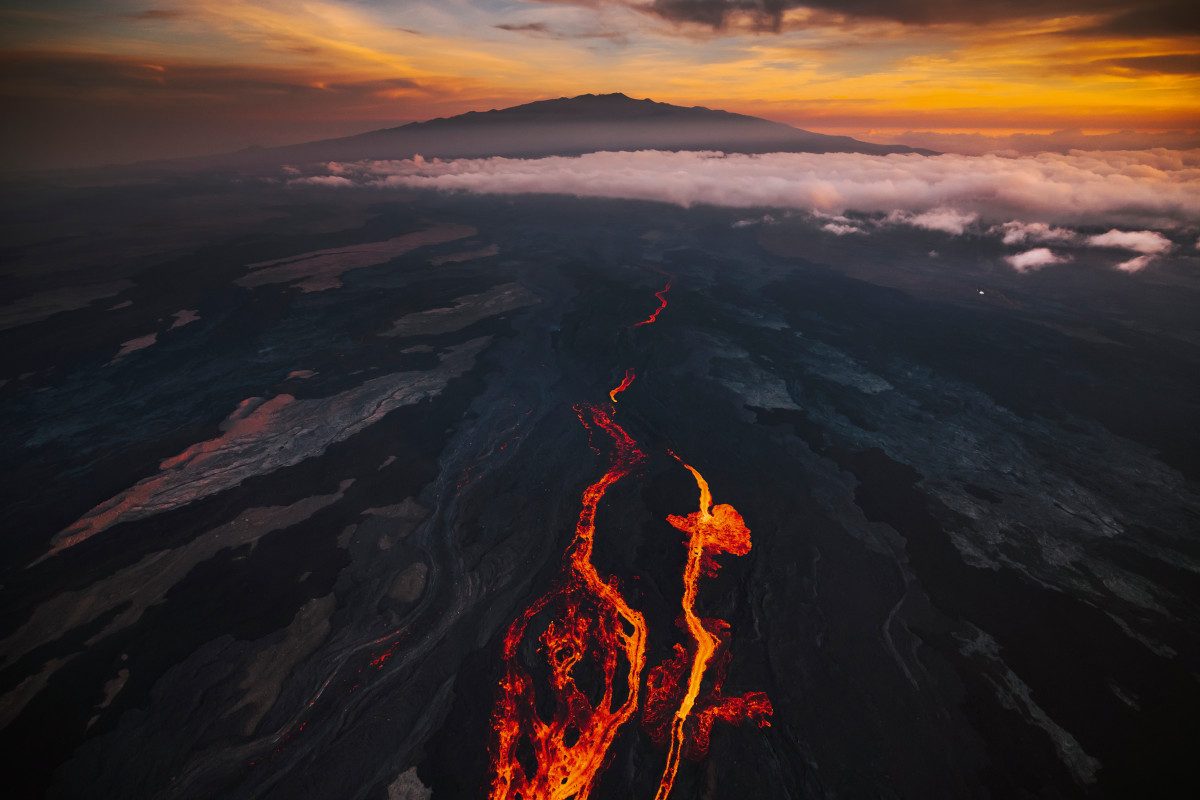 In an aerial view, lava fissures flow downslope from the north flank of Mauna Loa Volcano in Hilo, Hawaii