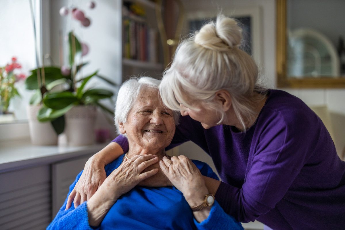 Two elderly women embracing