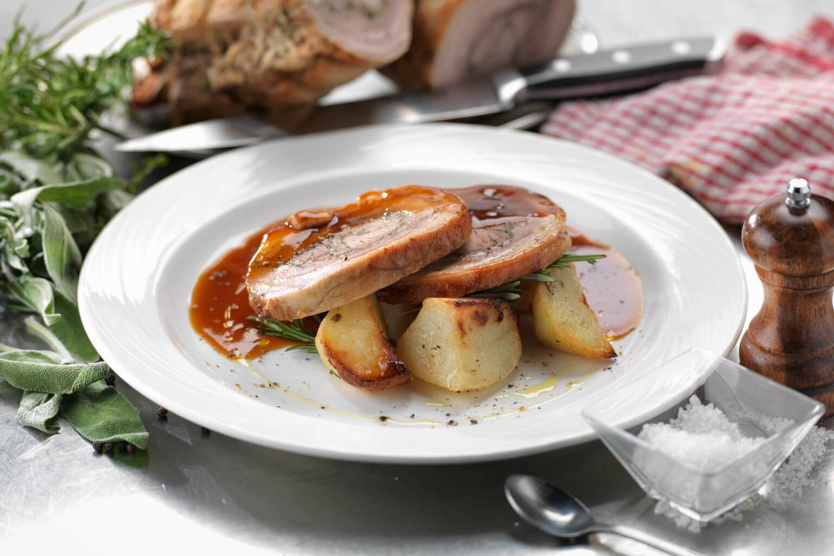 Photo of a plate of pork, potatoes and gravy