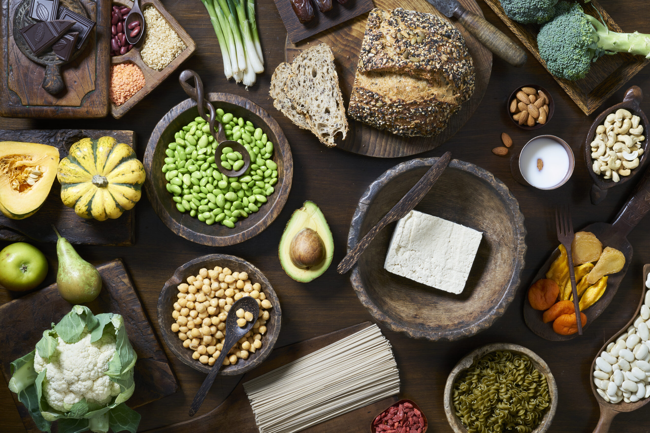 Overhead shot of healthy vegan food including fruit vegetables tofu and beans