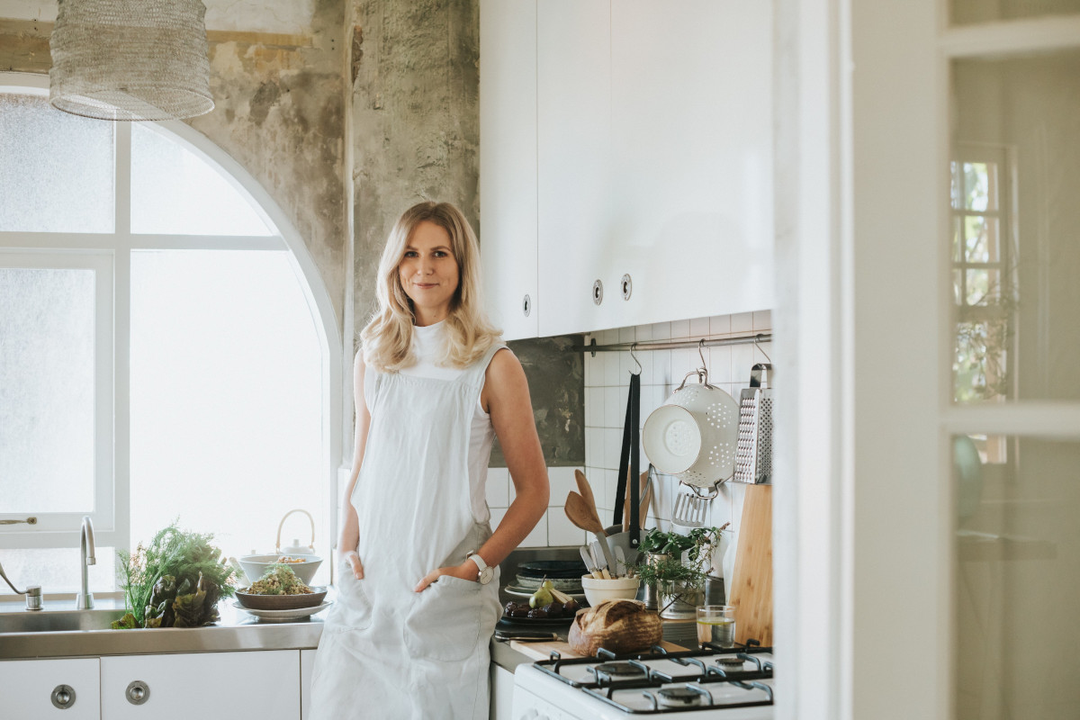 Dr Emily Leeming standing up in the kitchen. Hands in her pockets