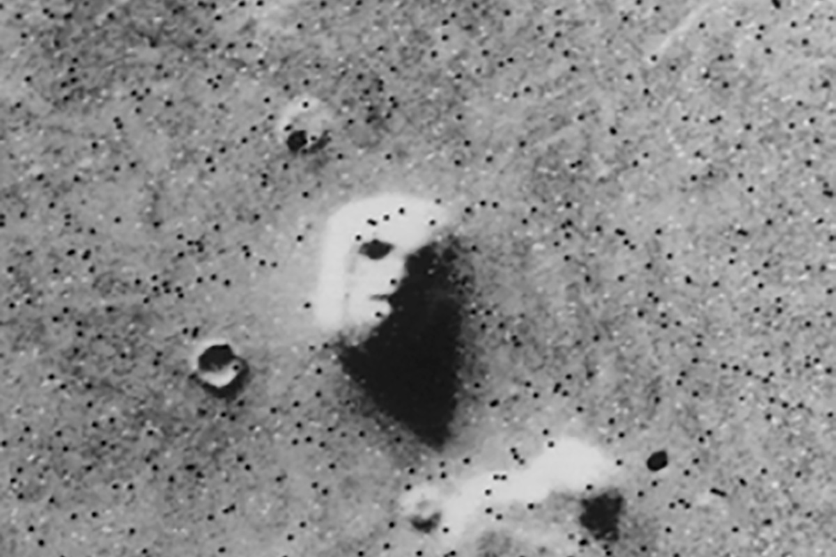 A hill that with stark shadows that resembles a human face