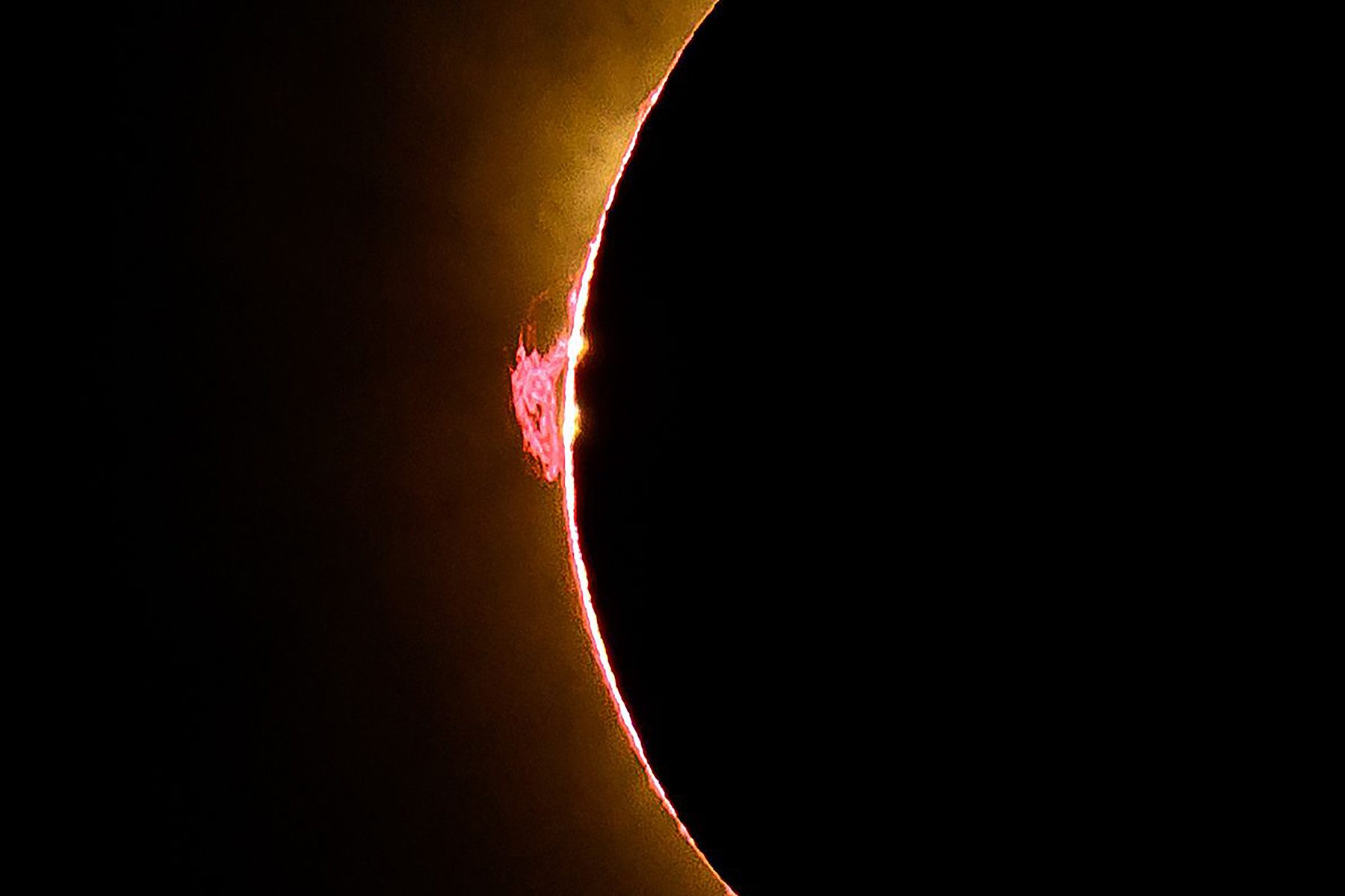 a bright red flare sprouting from the limb of the Sun 