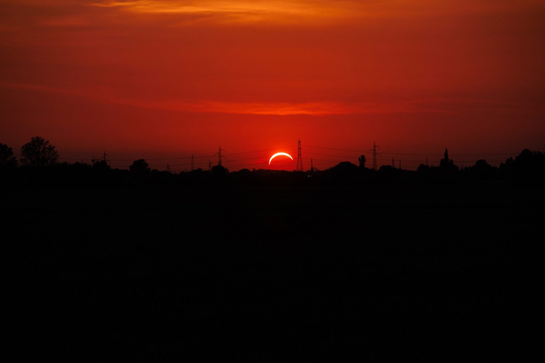 Crescent sun over the horizon