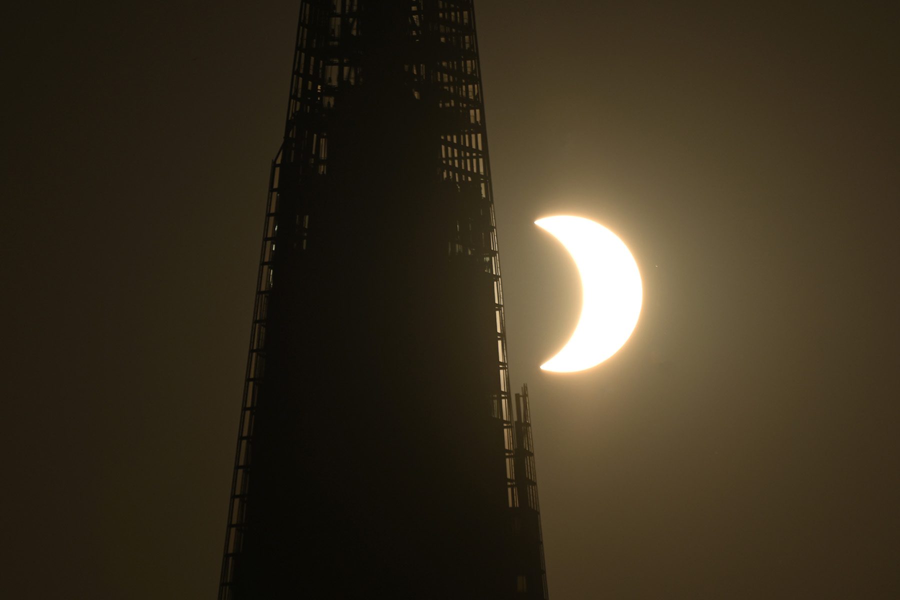 the crescent of the Sun next to the shard