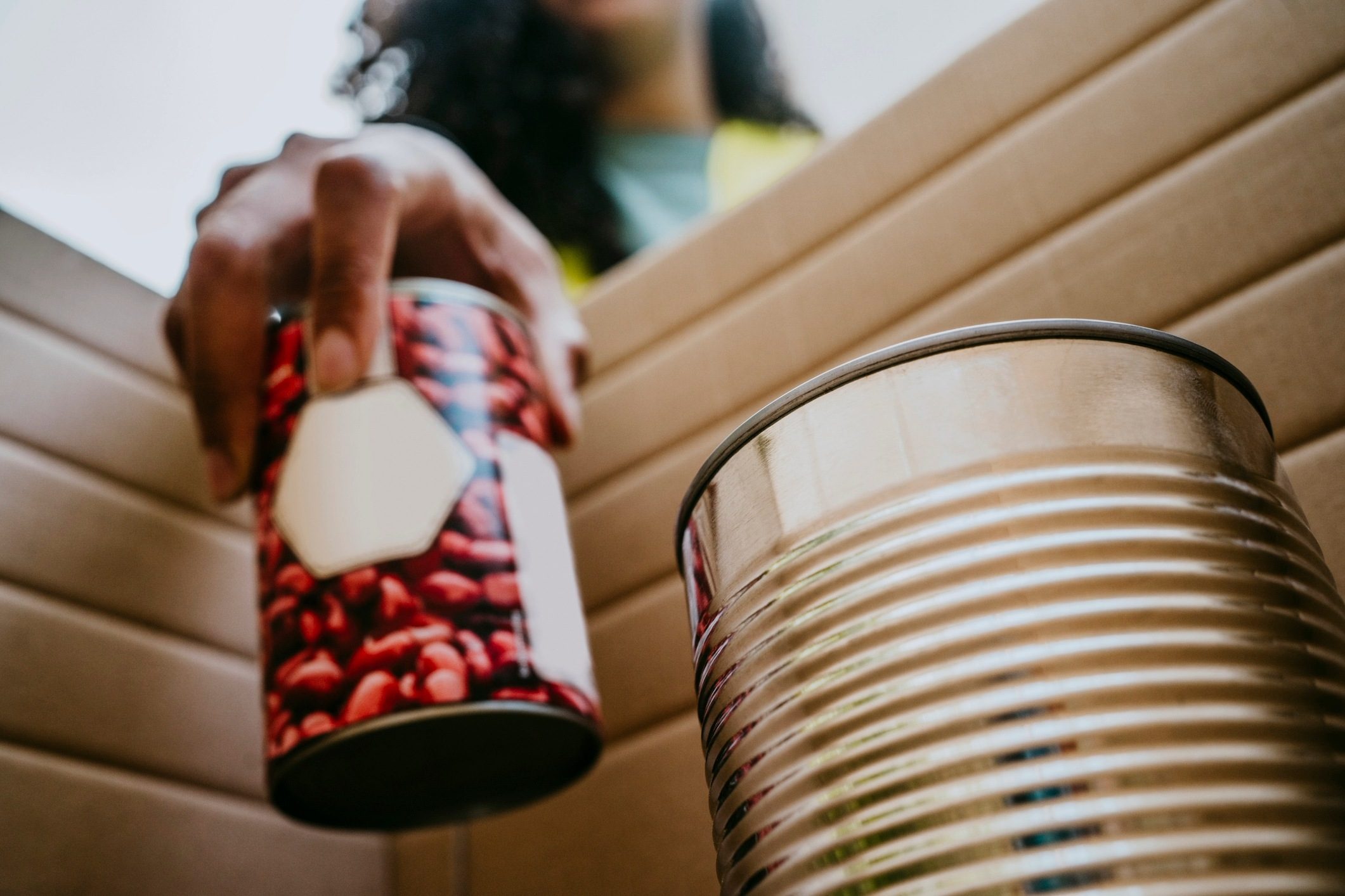Woman putting tins into a box.