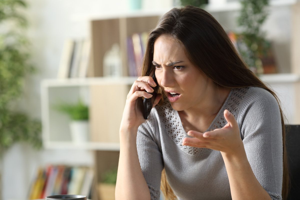 A woman speaking angrily on a mobile phone.
