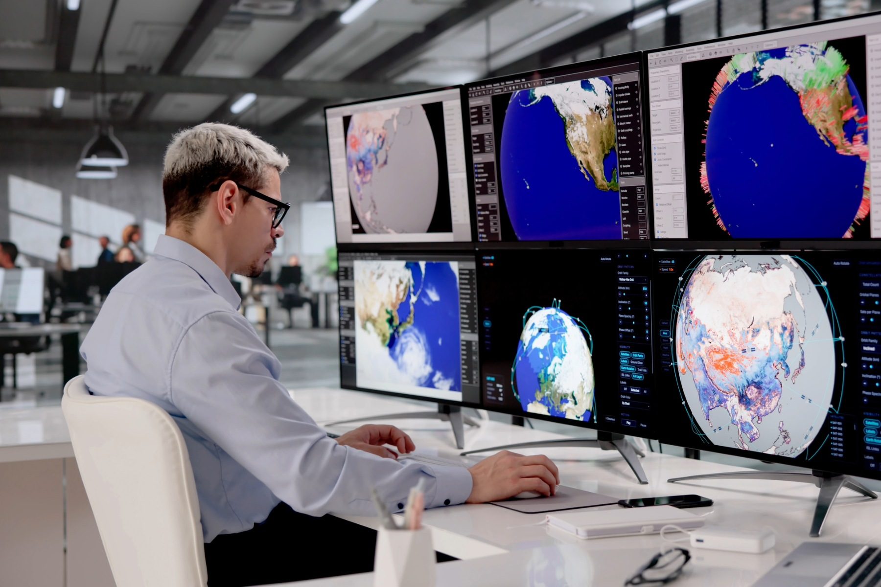 meteorologist in front of screens