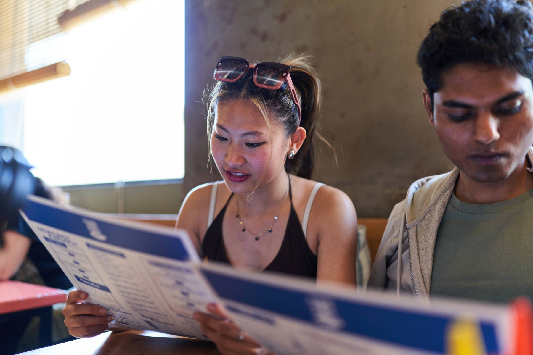 Young woman browsing a restaurant menu