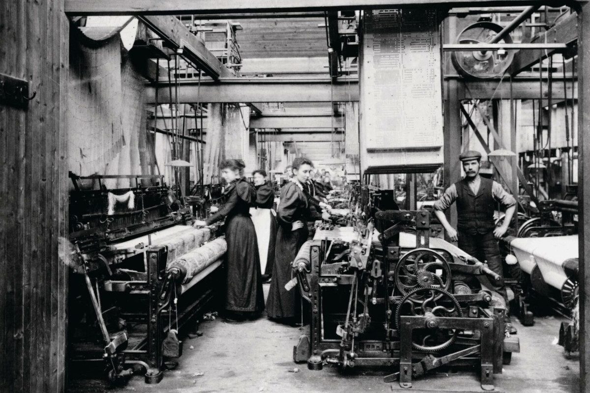 An old black and white photograph of people working in a textile factory