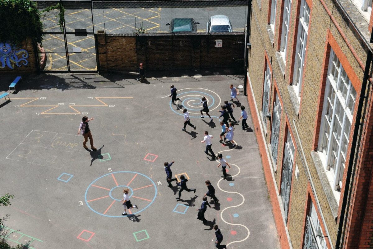 Aerial view of children playing outside at school