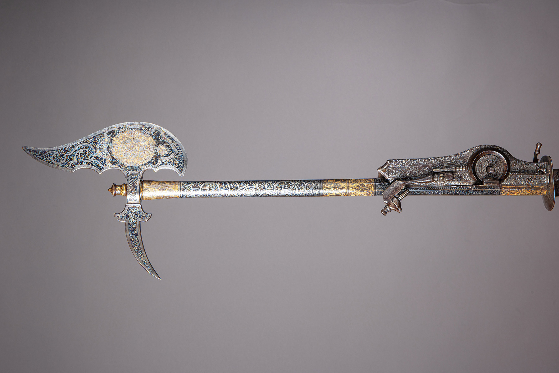 Antique rifle with axe on barrel
