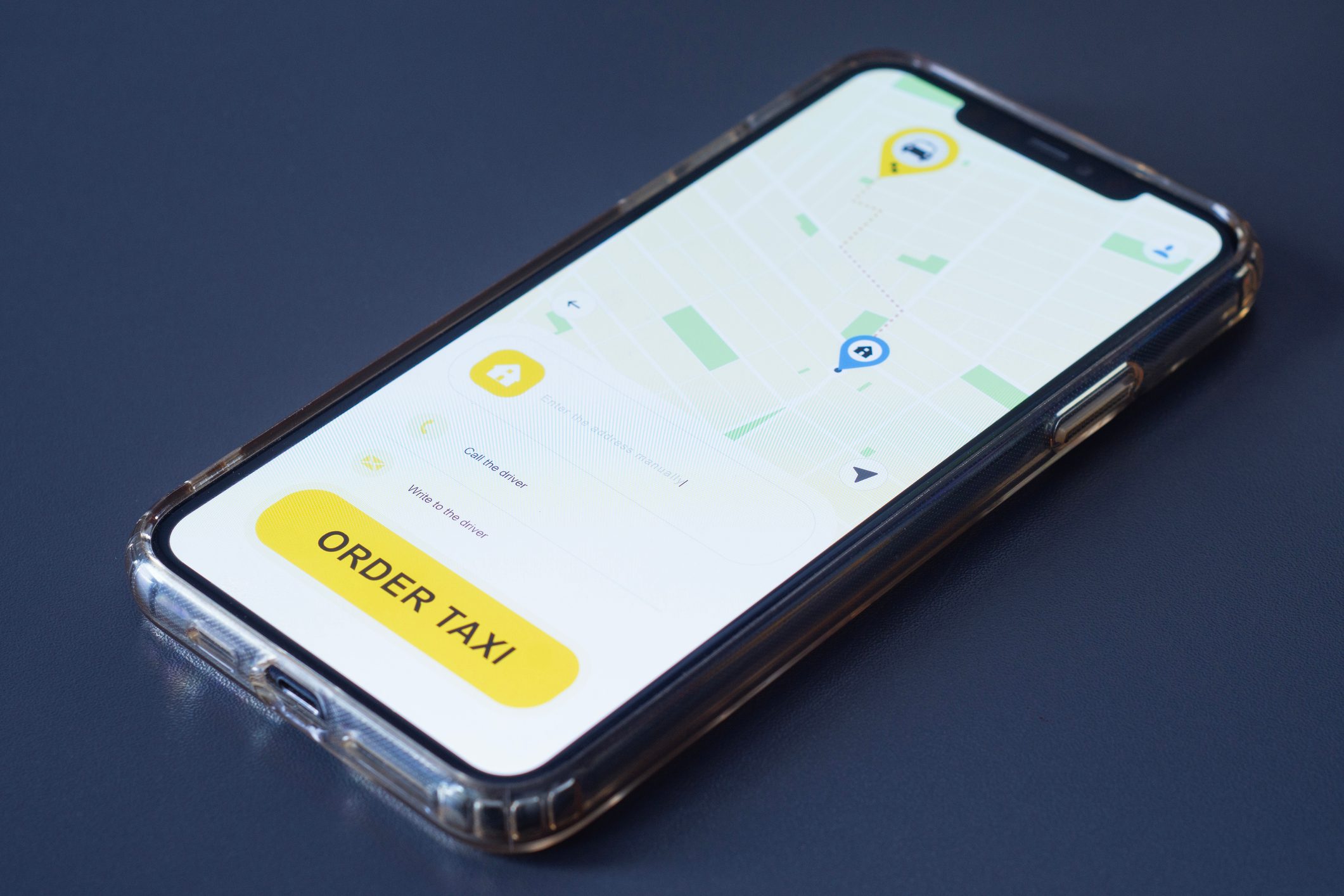 Mobile phone displaying a ride hailing app with an order taxi button and city map. Concept modern urban transportation services, digital mobility and smart city technology