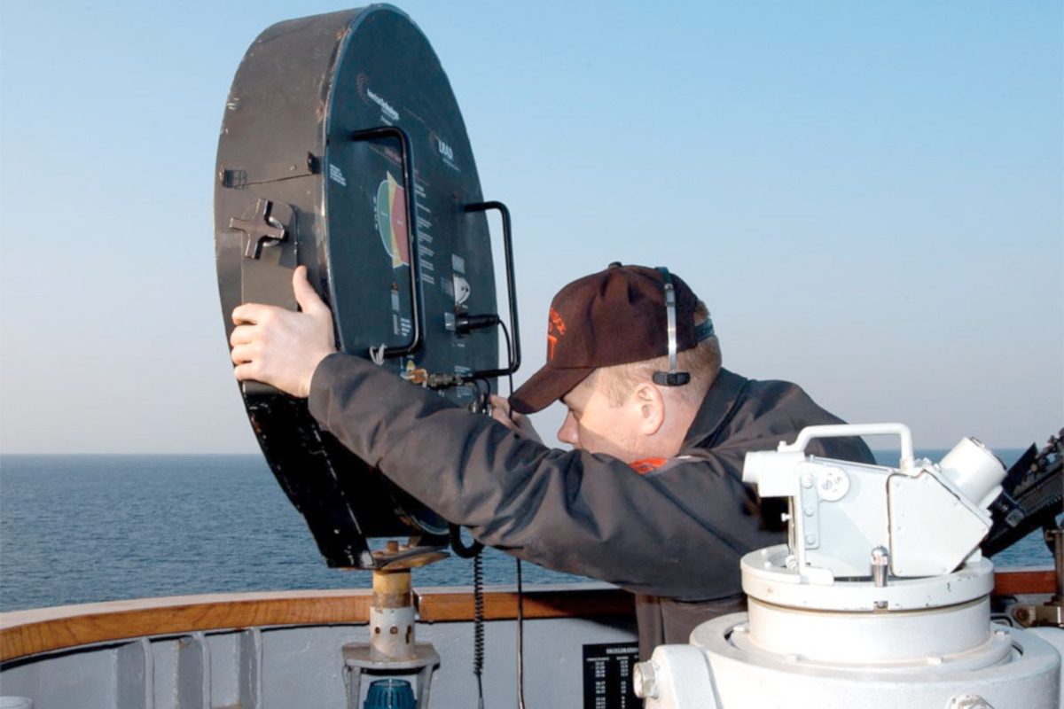A navy officer is operating a sonic weapon