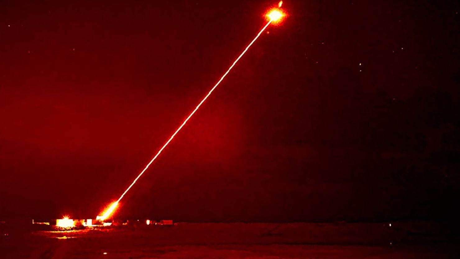 A beam from the DragonFire laser weapon system illuminates a target during a successful trial in 2024