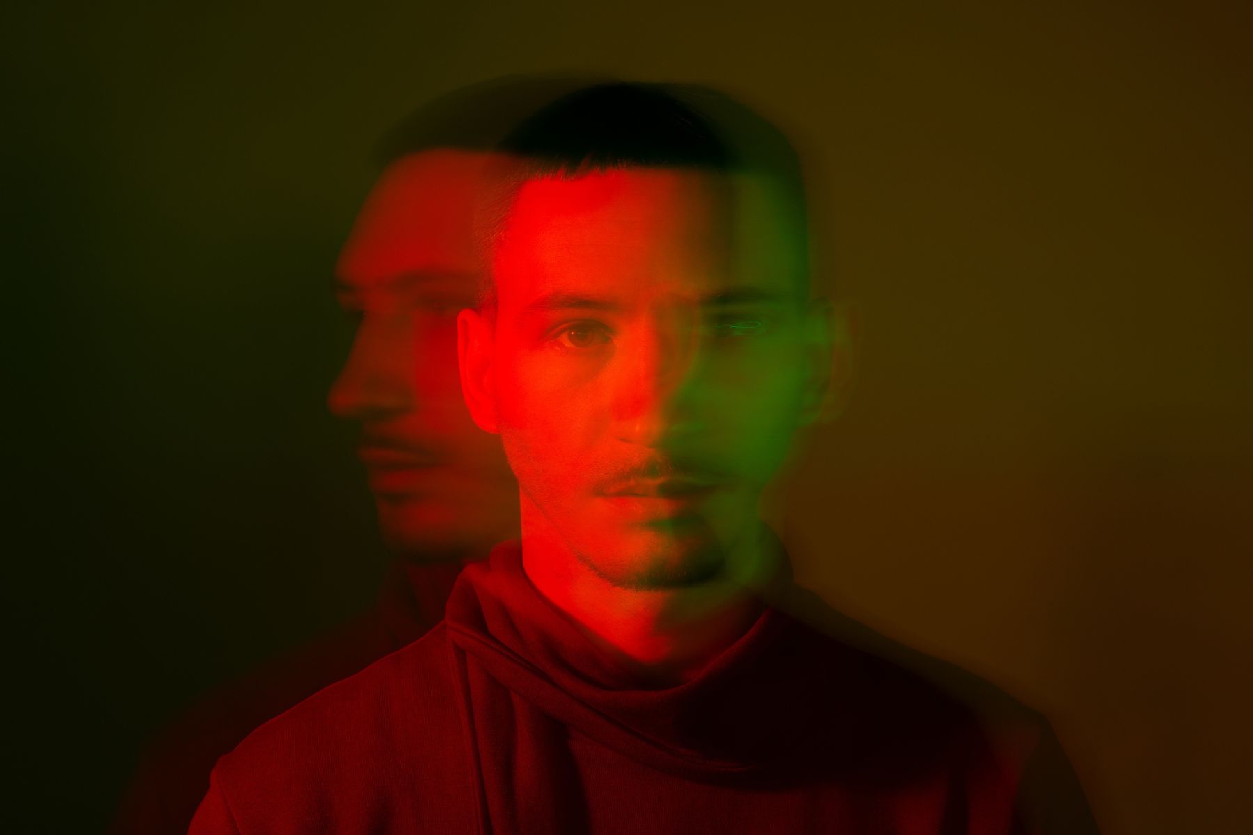 A smudgy image of a man in red lighting
