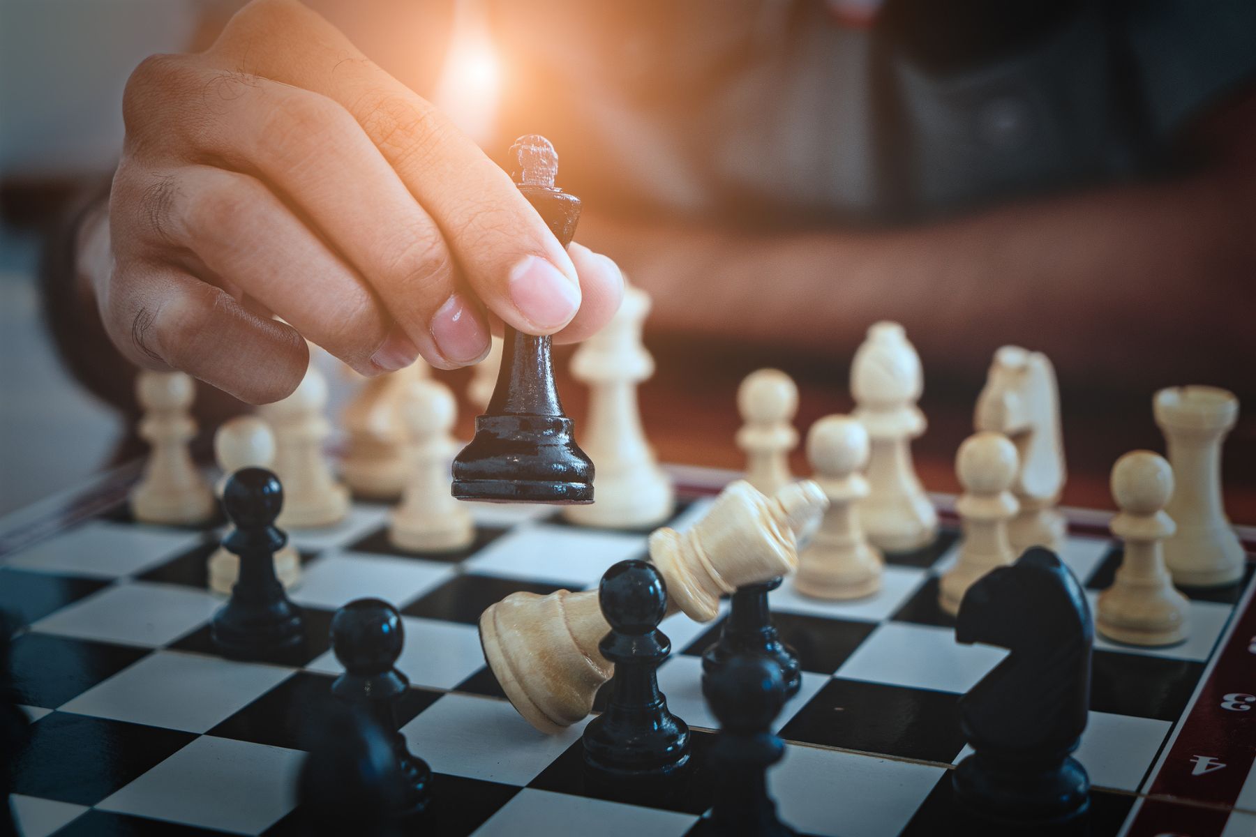 Someone moves a pawn on a chess board