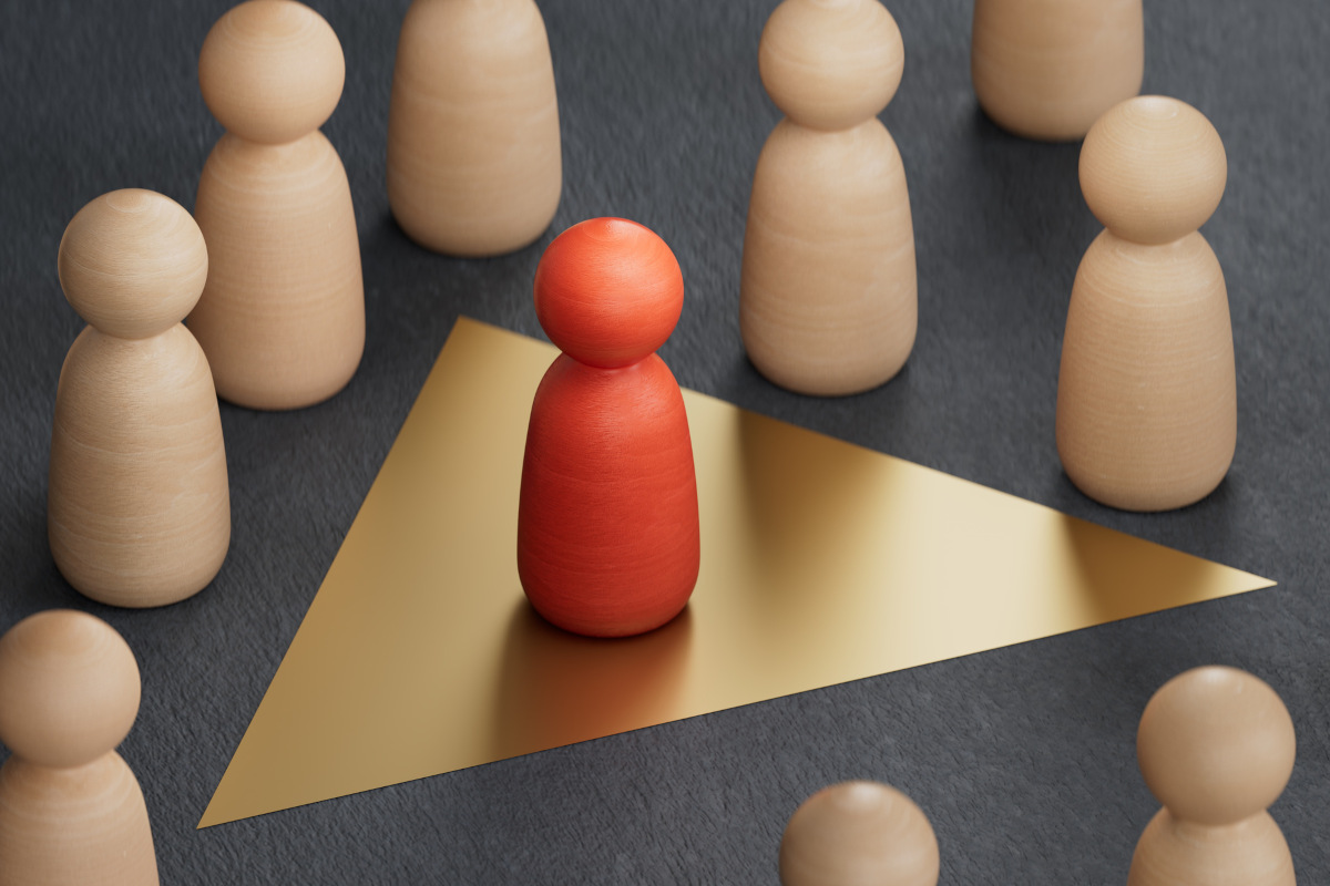 Psychological disorder concept. Dark triad and anti-social personality traits – board game pieces, one is red, in a golden triangle, separate from the others