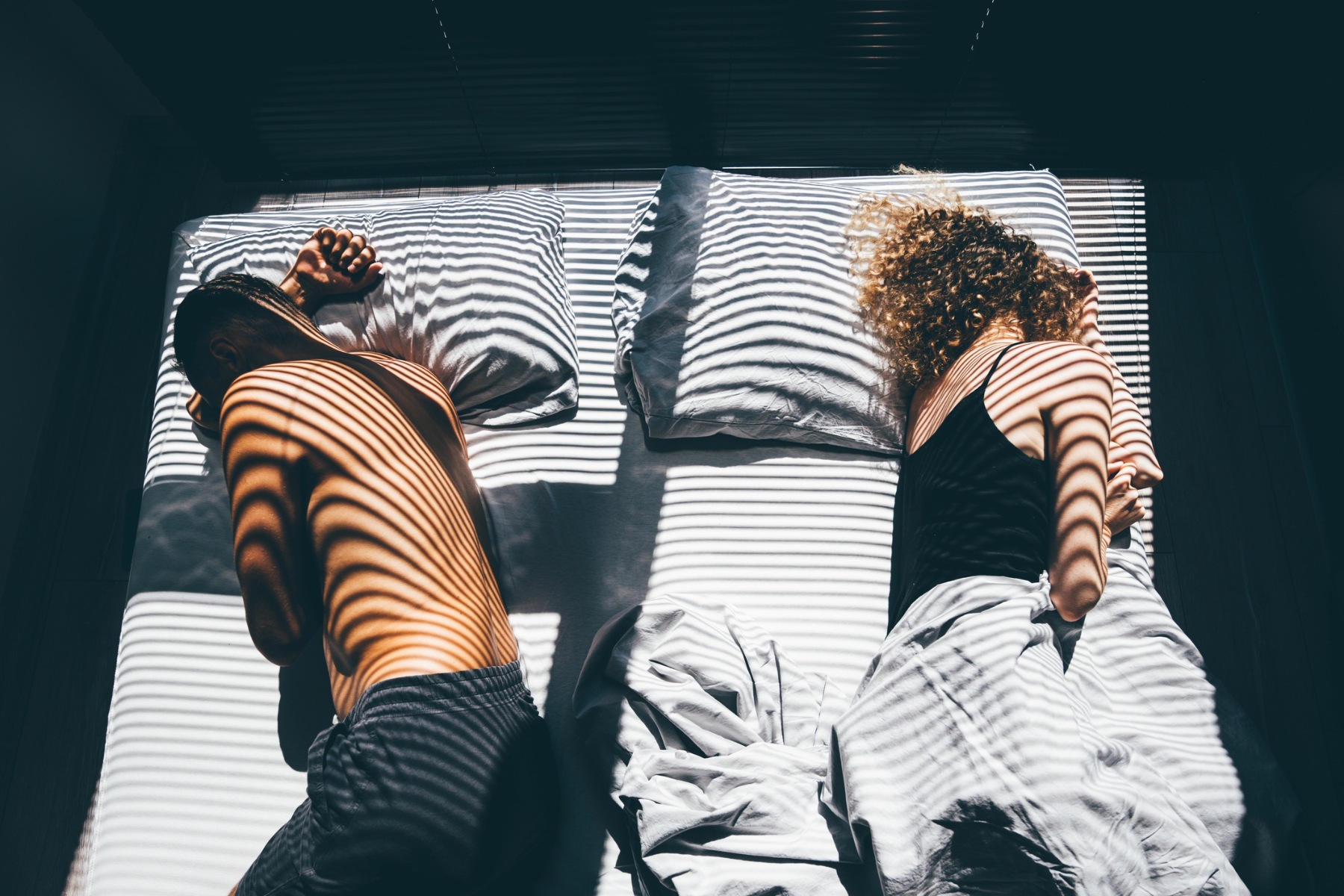 Couple lying far apart in bed