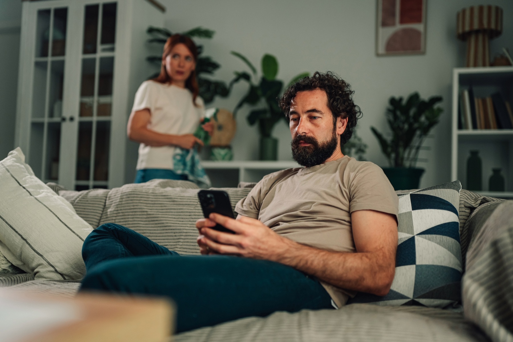 Man ignoring wife to look at phone