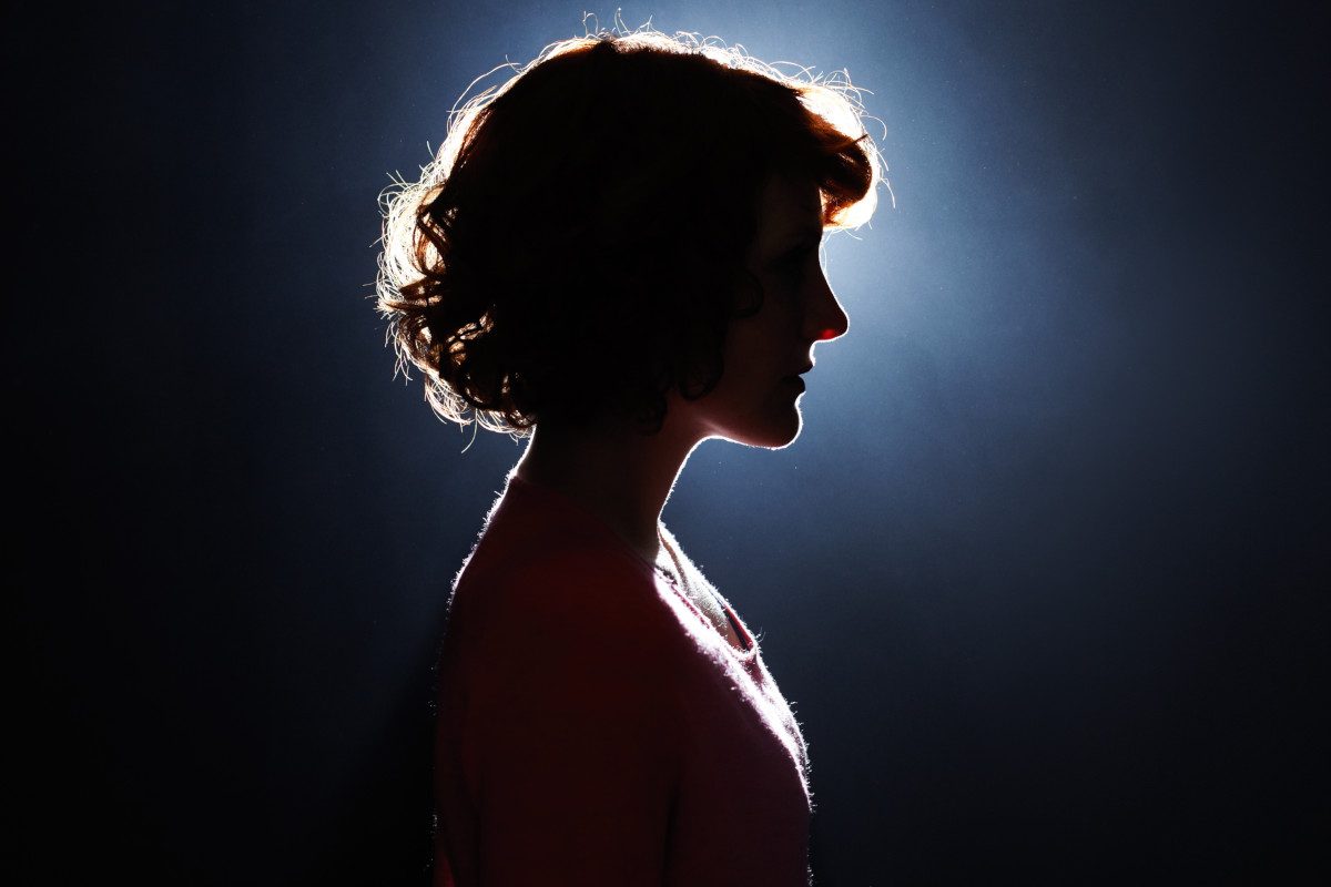 Silhouette of a person with the light coming from behind them.
