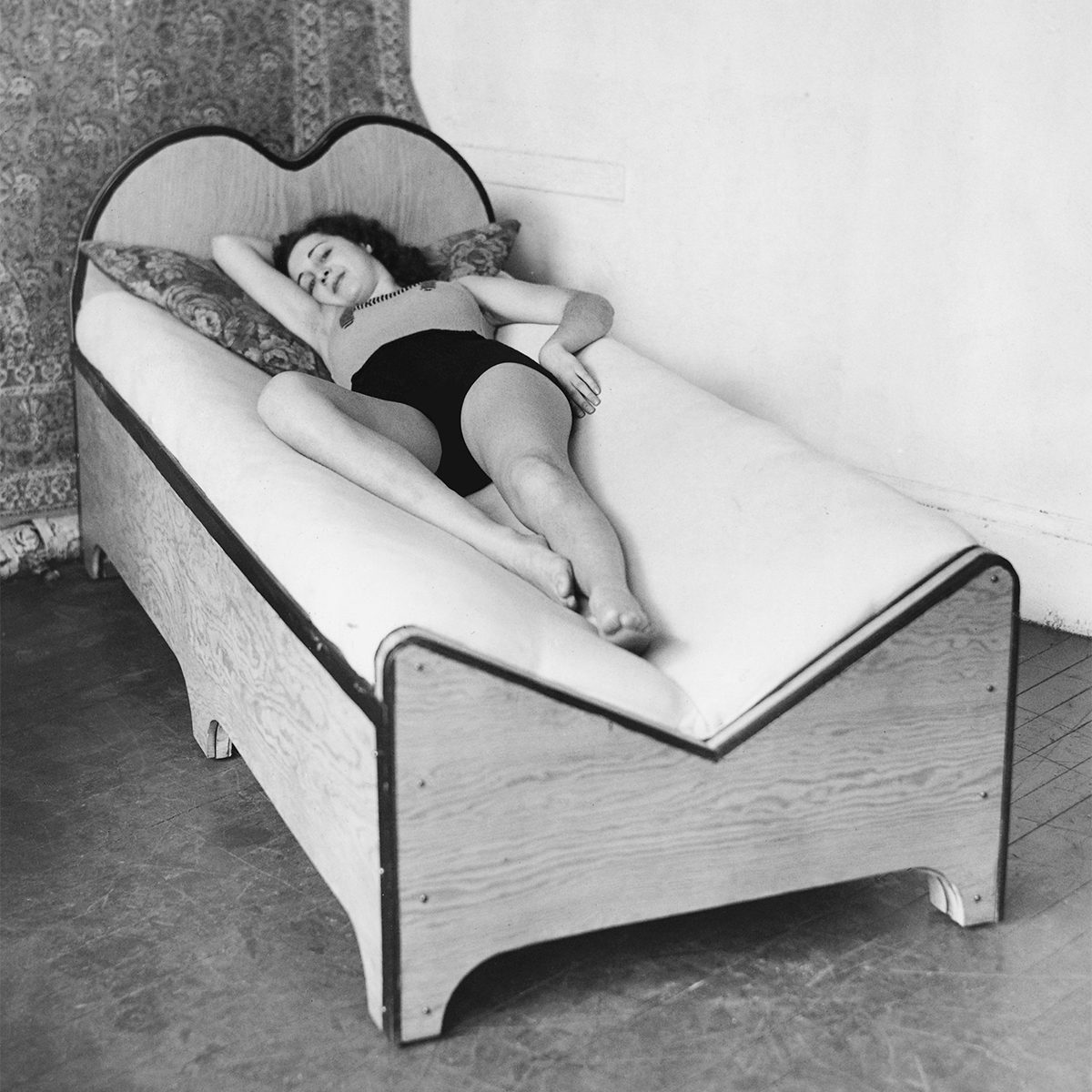 Woman lying in a v-shped bed.