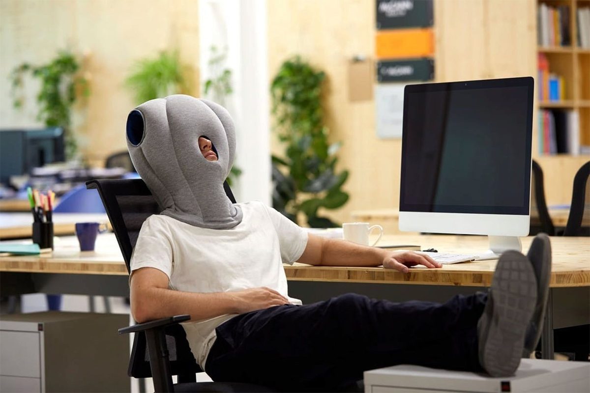 Man with pillow on head.